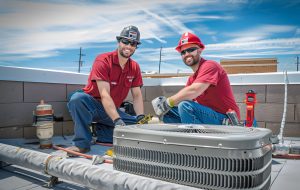 two men wearing red shirts one wearing red hat